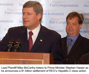 Lead Plaintiff Mike McCarthy listens to Prime Minister Stephen Harper as he announces a $1 billion settlement of Roy O'Connor's Hepatitis C class action